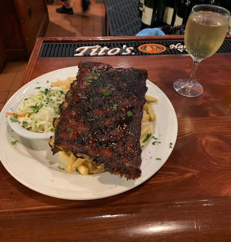 Half rack of ribs with fries and coleslaw at the bar